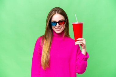 Young woman holding soda while watching a 3D movie with happy expression