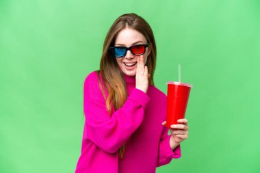 Young woman holding soda while watching a 3D movie whispering something
