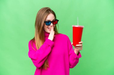 Young woman holding soda while watching a 3D movie with surprise and shocked facial expression