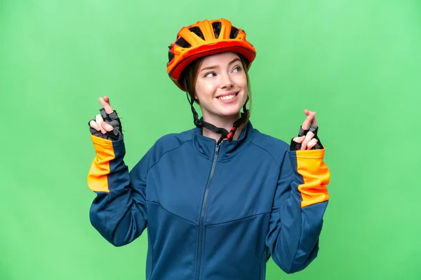 Young Cyclist Woman Isolated Chroma Key Background Fingers Crossing — Stockfoto