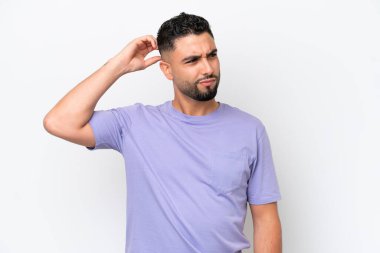 Young Arab handsome man isolated on white background having doubts while scratching head
