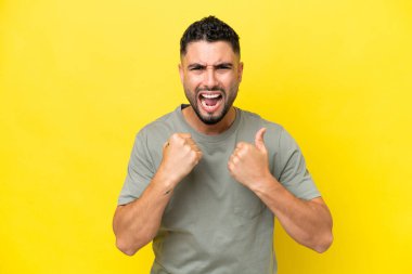 Young Arab handsome man isolated on yellow background frustrated by a bad situation