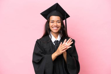 Young university Colombian woman graduate isolated on pink background applauding after presentation in a conference