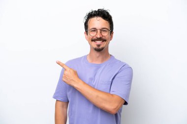 Young man with moustache isolated on white background pointing to the side to present a product