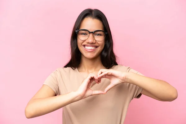 Young Colombian Woman Isolated Pink Background Glasses Making Heart Hands — Stock Photo, Image