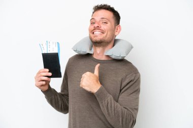 Young caucasian man holding a passport isolated on white background proud and self-satisfied
