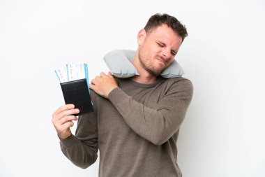 Young caucasian man holding a passport isolated on white background suffering from pain in shoulder for having made an effort
