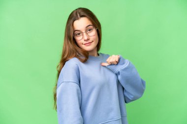 Teenager girl over isolated chroma key background proud and self-satisfied