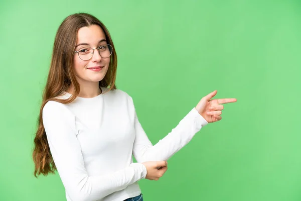 Teenager Girl Isolated Chroma Key Background Pointing Finger Side — Stockfoto