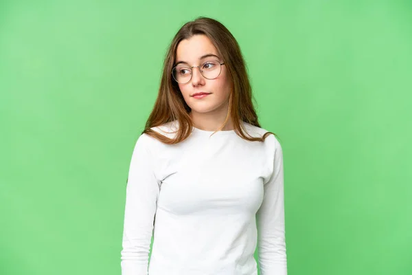 Teenager Girl Isolated Chroma Key Background Making Doubts Gesture Looking — Stockfoto