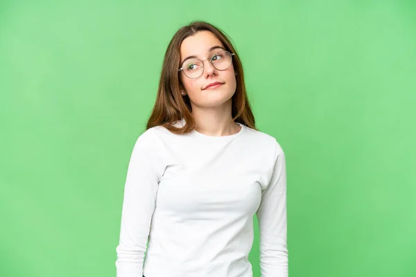 Teenager Girl Isolated Chroma Key Background Having Doubts While Looking — Stock Fotó
