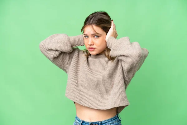 stock image Young girl over isolated chroma key background frustrated and covering ears