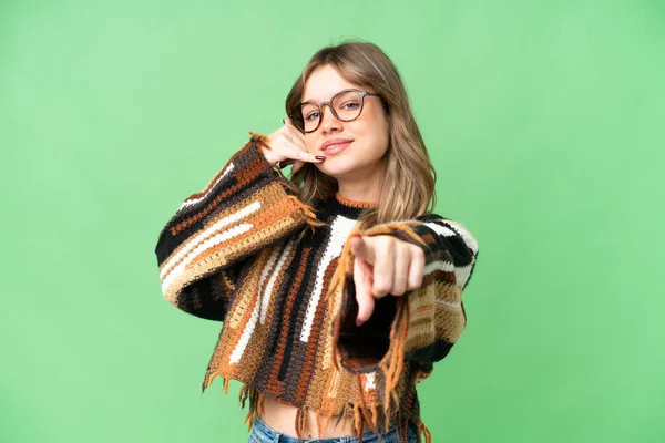 stock image Young girl over isolated chroma key background making phone gesture and pointing front