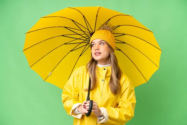 Young Girl Rainproof Coat Umbrella Isolated Chroma Key Background Thinking — Stock Photo, Image
