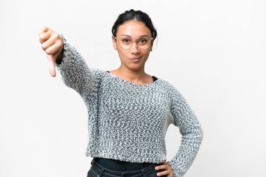 Young Uruguayan woman over isolated white background showing thumb down with negative expression