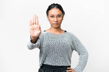 Young Uruguayan woman over isolated white background making stop gesture and disappointed