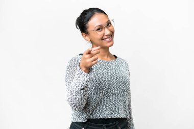 Young Uruguayan woman over isolated white background pointing front with happy expression