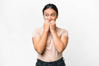 Young Uruguayan woman over isolated white background nervous and scared putting hands to mouth