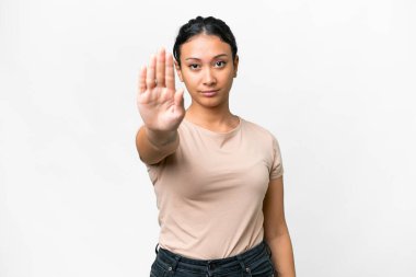 Young Uruguayan woman over isolated white background making stop gesture