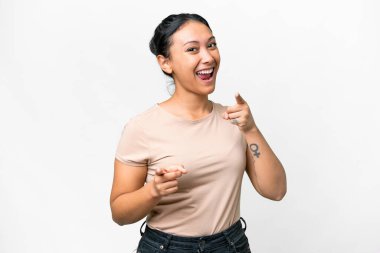 Young Uruguayan woman over isolated white background surprised and pointing front
