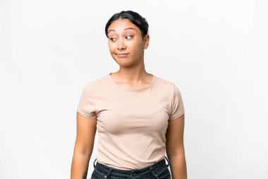 Young Uruguayan woman over isolated white background making doubts gesture looking side