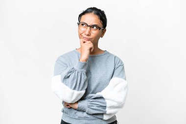 Young Uruguayan woman over isolated white background having doubts