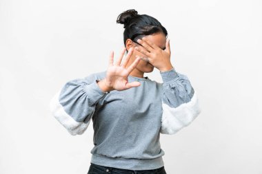 Young Uruguayan woman over isolated white background nervous stretching hands to the front