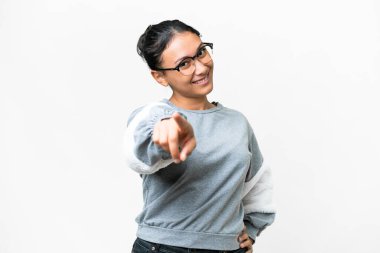 Young Uruguayan woman over isolated white background pointing front with happy expression