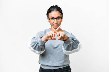 Young Uruguayan woman over isolated white background making stop gesture with her hand to stop an act