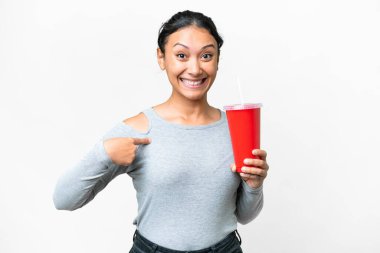 Young Uruguayan woman holding soda over isolated white background with surprise facial expression