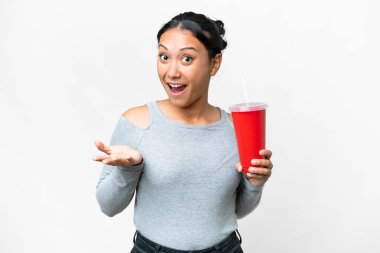 Young Uruguayan woman holding soda over isolated white background with shocked facial expression