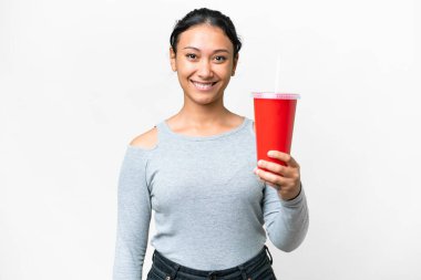 Young Uruguayan woman holding soda over isolated white background with happy expression