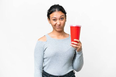 Young Uruguayan woman holding soda over isolated white background with sad expression