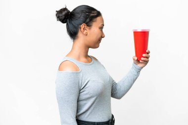 Young Uruguayan woman holding soda over isolated white background with happy expression