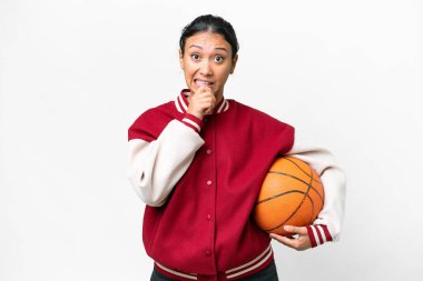 Young Uruguayan woman playing basketball over isolated wall  over isolated white background having doubts and thinking