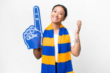 sports fan woman over isolated white background saluting with hand with happy expression