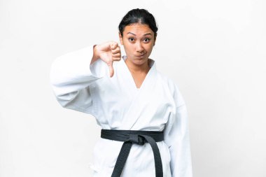 Young Uruguayan woman doing karate over isolated white background showing thumb down with negative expression