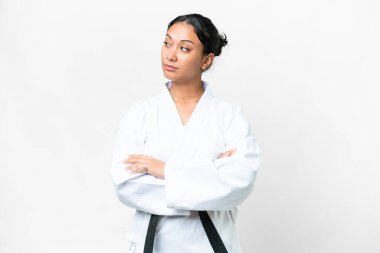 Young Uruguayan woman over isolated white background doing karate keeping the arms crossed