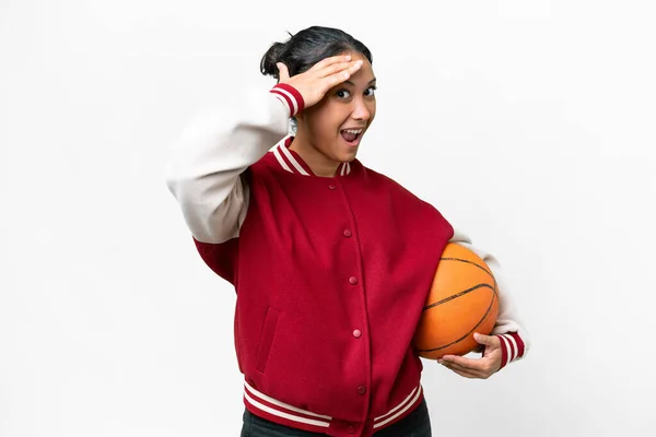 stock image Young Uruguayan woman playing basketball over isolated wall  over isolated white background doing surprise gesture while looking to the side