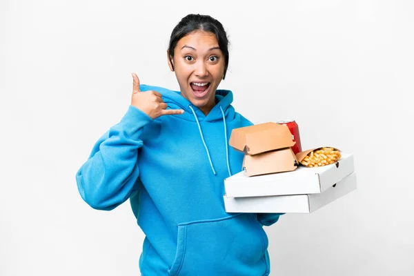 Young Uruguayan Woman Holding Pizzas Burgers Isolated White Background Making — стоковое фото