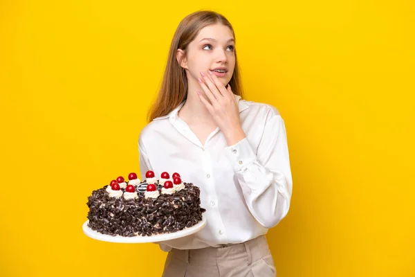 Teenager Russian Girl Holding Birthday Cake Isolated Yellow Background Looking — Stock Photo, Image
