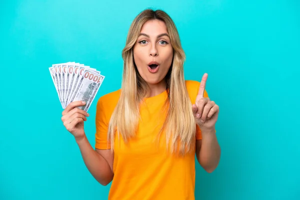 Young Uruguayan Woman Taking Lot Money Isolated Blue Background Intending — 图库照片