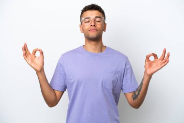 Young caucasian Brazilian man isolated on white background in zen pose