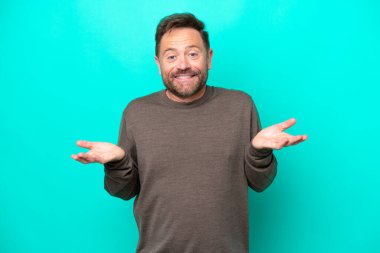 Middle age caucasian man isolated on blue background happy and smiling