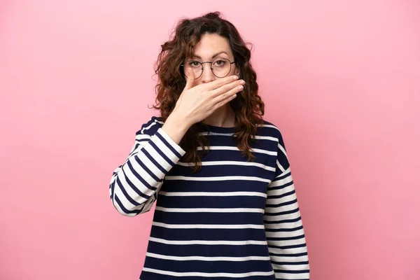 stock image Young caucasian woman isolated on pink background covering mouth with hand