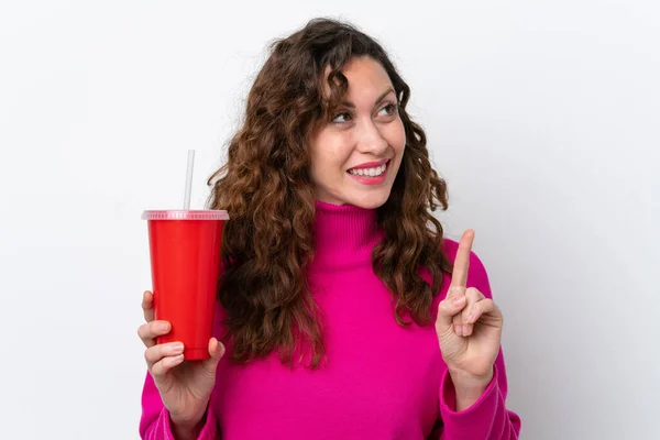 Young Caucasian Woman Drinking Soda Isolated White Background Intending Realizes — стоковое фото