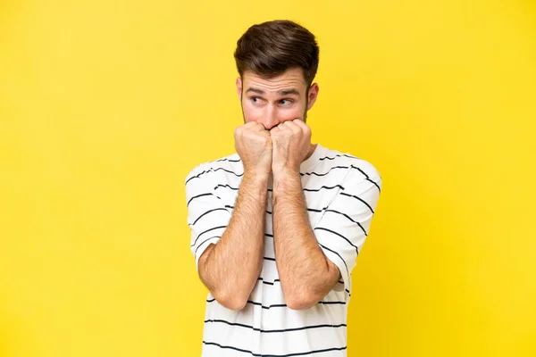 Young Caucasian Man Isolated Yellow Background Nervous Scared Putting Hands — Stock Photo, Image