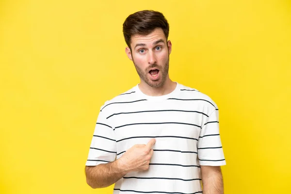 stock image Young caucasian man isolated on yellow background pointing to oneself