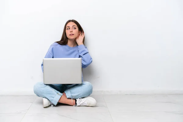 Young Caucasian Woman Laptop Sitting Floor Isolated White Background Listening — Stock Fotó