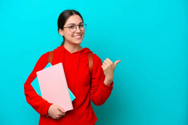 Young Student Caucasian Woman Isolated Blue Background Pointing Side Present — 스톡 사진